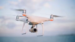 A quadcopter drone with a camera in flight