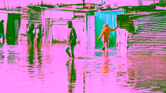 residents of a community walking through a flooded street