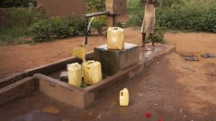 Cans being filled by a water pump