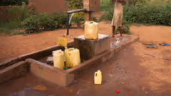 Cans being filled by a water pump
