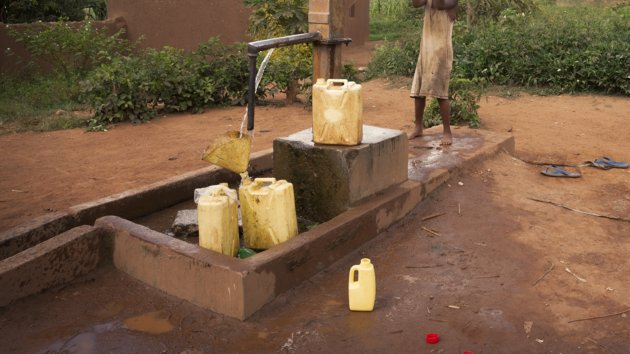 Cans being filled by a water pump