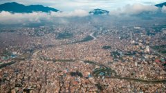 Aerial photo of a big city with mountains in the background