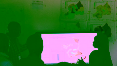 a group of people standing around a large computer screen that's displaying a map